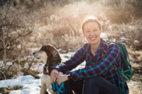 Casey and her dog Burt sitting on a trail